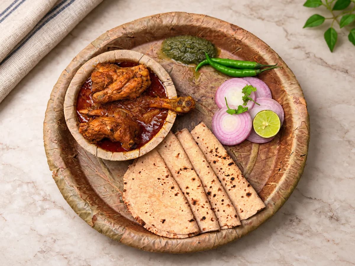 Pattal Chicken with rotis, onion and green chutney on a leaf pattal
